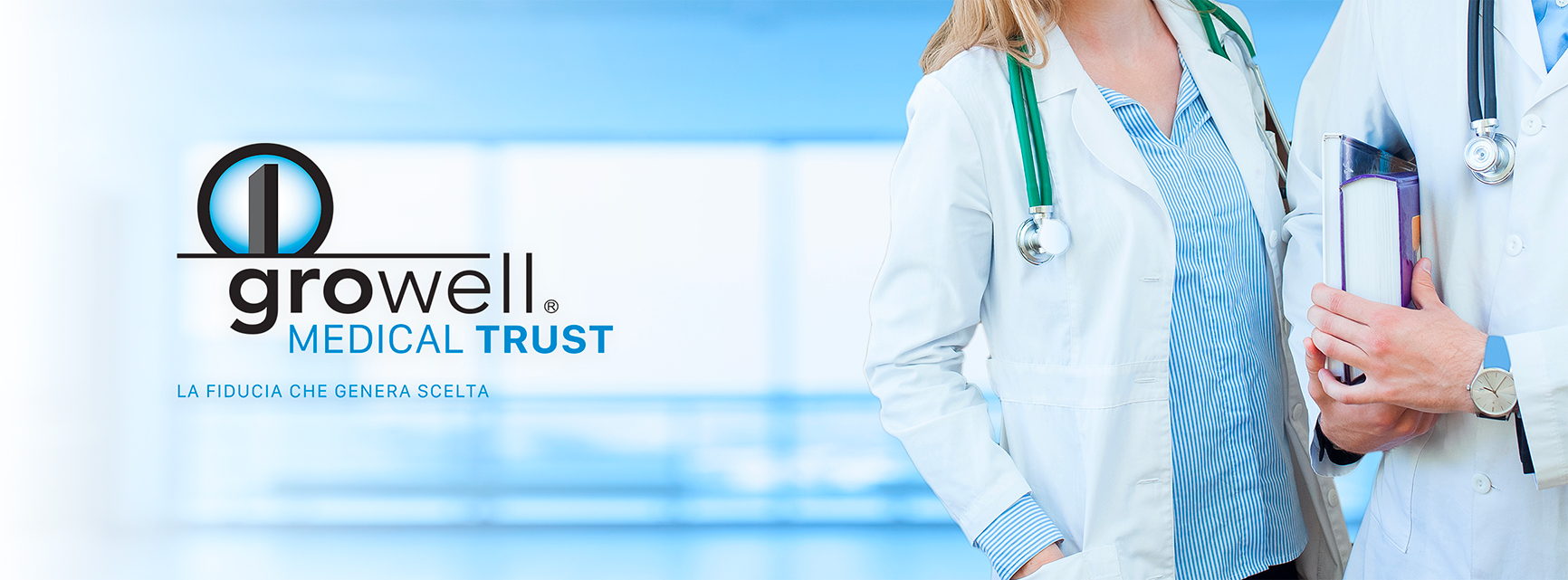 Logo Growell Medical Trust accanto a due professionisti sanitari in camice bianco